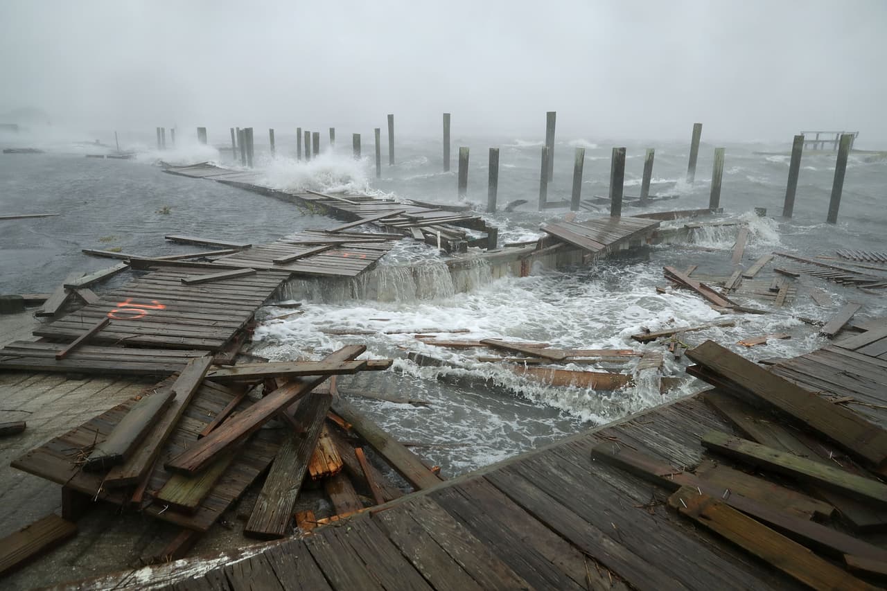 ATLANTIC BEACH, NC - SEPTEMBER 13: Portions of a boat dock and boardwalk are destroyed by powerful wind and waves as Hurricane Florence arrives September 13, 2018 in Atlantic Beach, United States. Coastal cities in North Carolina, South Carolina and Virginia are under evacuation orders as the Category 2 hurricane approaches the United States. (Photo by Chip Somodevilla/Getty Images)