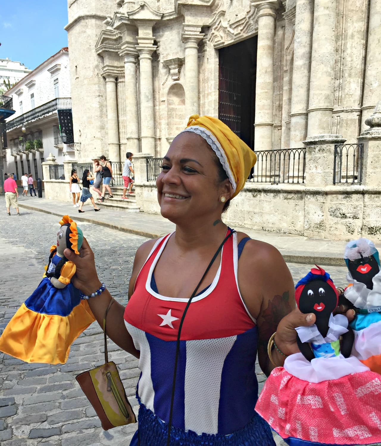 A Cuban woman sells homemade souvenir dolls in the Cathedral Plaza in Old Havana, Cuba.