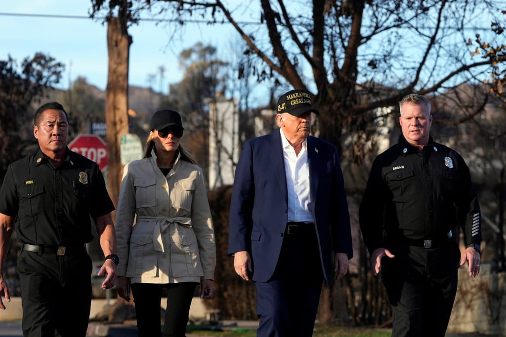 President Donald Trump, center right, and first lady Melania Trump walk, center left, walk with Jason Hing, chief deputy of emergency services at the Los Angles Fire Department, left, and Capt. Jeff Brown, Chief of Station 69, as they tour the Pacific Palisades neighborhood affected by recent wildfires in Los Angeles, Jan. 24, 2025. (AP Photo/Mark Schiefelbein, File)