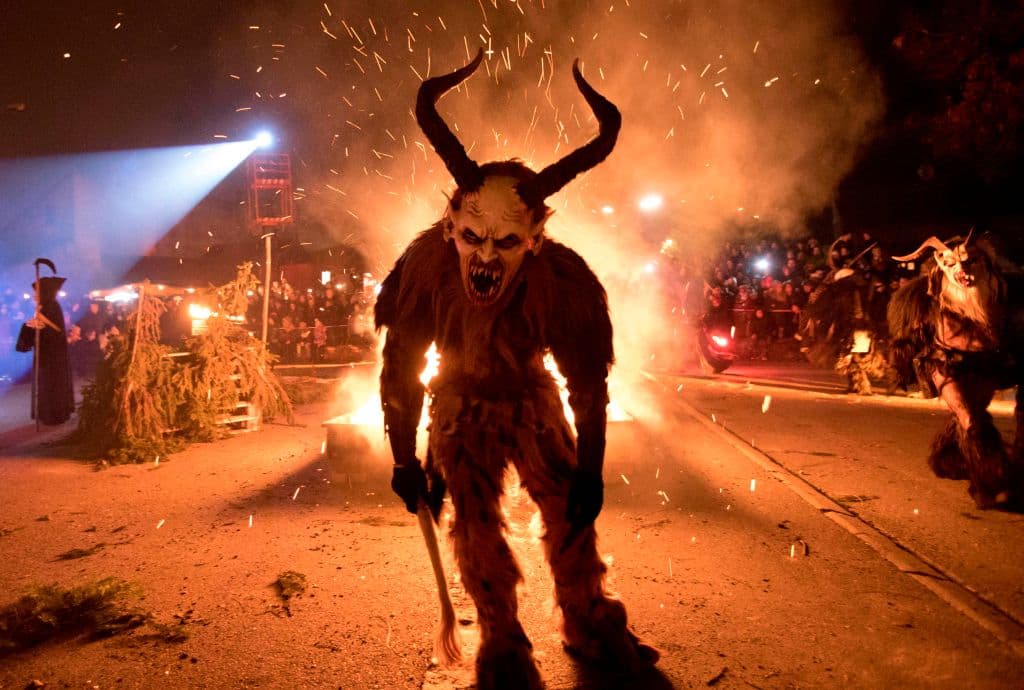 A participant performs during a procession of 'Krampus' monsters in Schwadorf, Austria on November 24, 2017. Krampus is traditionally the evil sidekick of Santa, sent to frighten naughty children and "evil spirits" in the run-up for Christmas. / AFP PHOTO / ALEX HALADA (Photo credit should read ALEX HALADA/AFP/Getty Images)