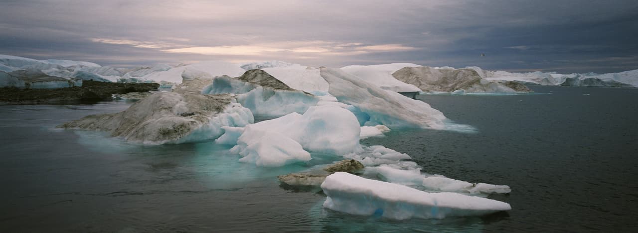 ILIMANAQ, GREENLAND - AUGUST 26, 2007: (ISRAEL OUT) Icebergs float in the water near the village of Ilimanaq, August 26, 2007 , Greenland. Scientists believe that Greenland, with its melting ice caps and disappearing glaciers, is an accurate thermometer of global warming. (Photo by Uriel Sinai/Getty Images)