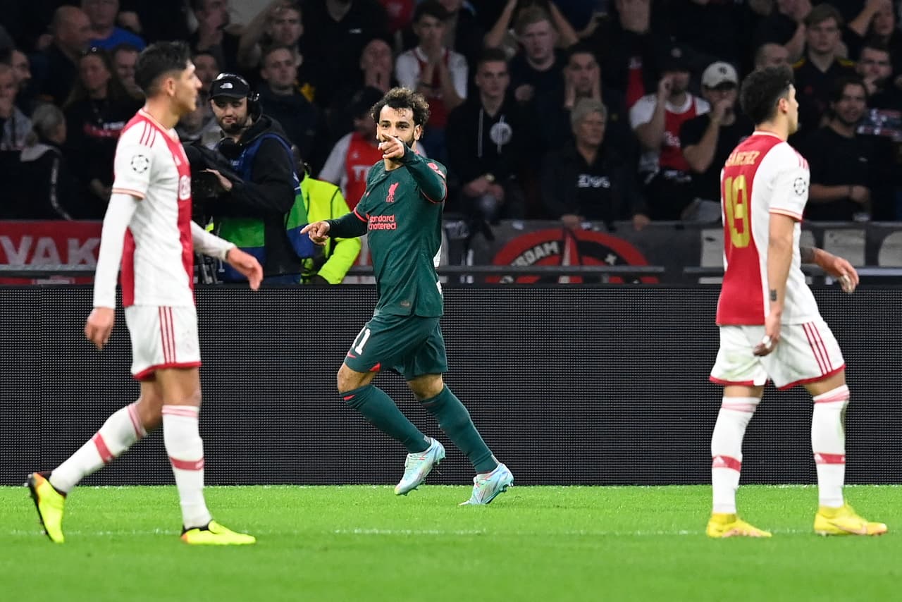Liverpool's Egyptian striker Mohamed Salah (C) celebrates scoring his team's first goal during the UEFA Champions League group A football match between Ajax Amsterdam and Liverpool at the Johan Cruijff ArenA in Amsterdam, on October 26, 2022. (Photo by JOHN THYS / AFP) (Photo by JOHN THYS/AFP via Getty Images)