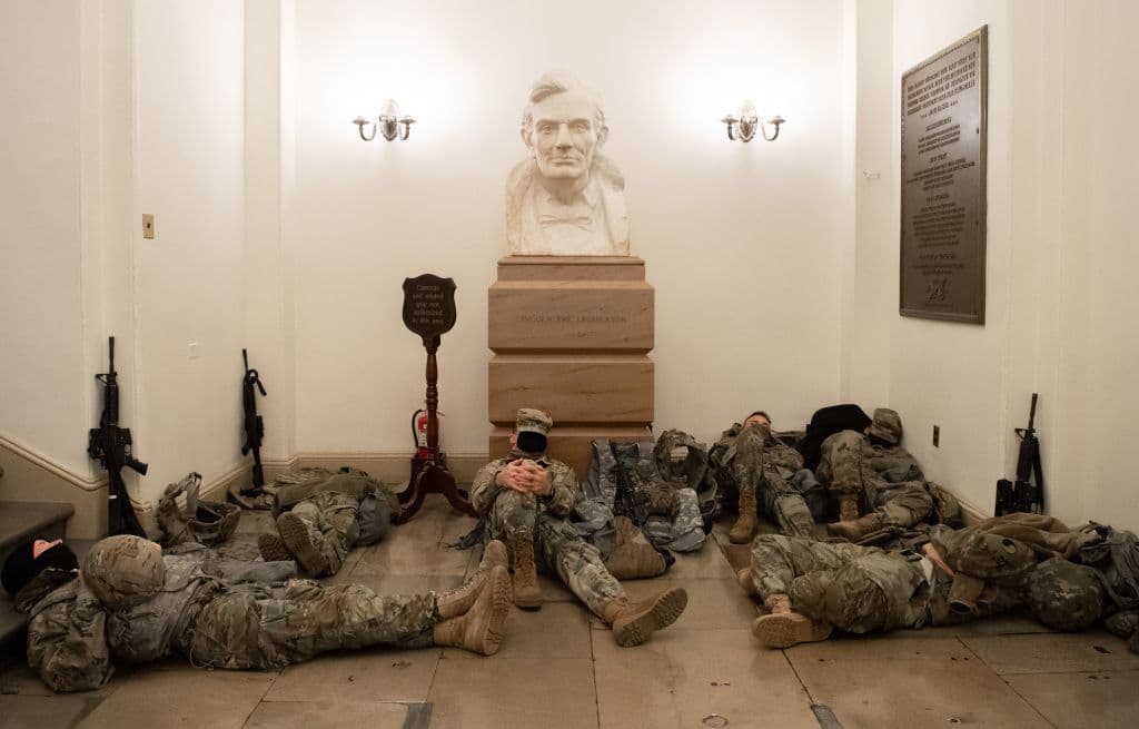 Members of the National Guard take a rest in the Rotunda of the US Capitol. The Pentagon has authorized up to 21,000 National Guard troops from around the country to assist law enforcement with security surrounding the inauguration of President-elect Joe Biden.