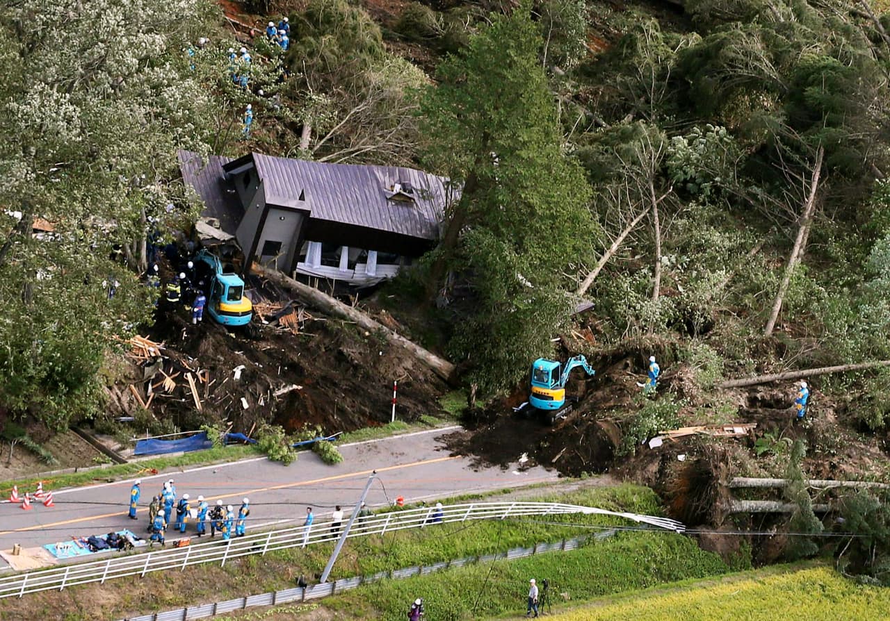 Police officers and rescue workers search for survivors from a building damaged by a landslide caused by a powerful earthquake in Atsuma town in Japan's northern island of Hokkaido, Japan, in this photo taken by Kyodo September 6, 2018. Mandatory credit Kyodo/via REUTERS ATTENTION EDITORS - THIS IMAGE WAS PROVIDED BY A THIRD PARTY. MANDATORY CREDIT. JAPAN OUT. NO COMMERCIAL OR EDITORIAL SALES IN JAPAN. THIS IMAGE WAS PROCESSED BY REUTERS TO ENHANCE QUALITY, AN UNPROCESSED VERSION HAS BEEN PROVIDED SEPARATELY.