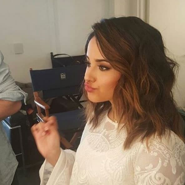 Becky G dándole un toque final a sus labios.