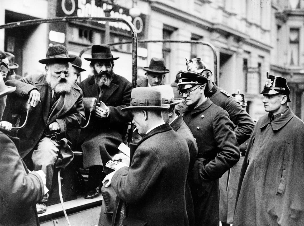 A busload of arrested Jewish men are questioned by government officials before being taken away in Berlin on April 11, 1933, shortly after Hitler's takeover of power in Germany. (AP Photo)