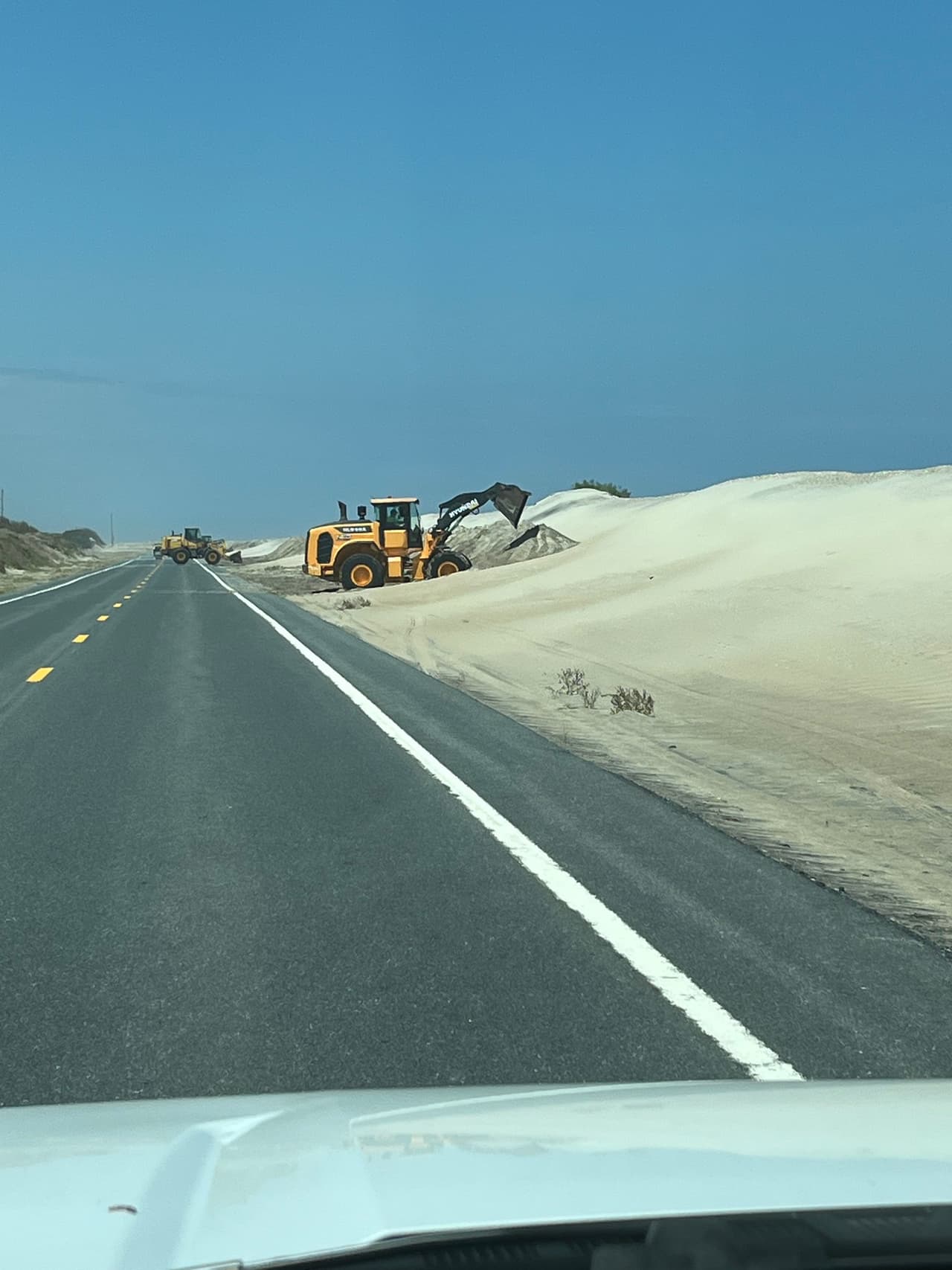 Esta imagen muestra el trabajo realizado este martes 19 de agosto en la Carretera 12 por grúas. 
<br>
<br>“
<b>Dados los vientos, la altura de las olas y la marejada ciclónica pronosticada, es probable que no sea suficiente.</b> Por favor, respeten las órdenes de evacuación y salgan sanos y salvos de las islas Ocracoke y Hatteras hoy”, indicó NCDOT.