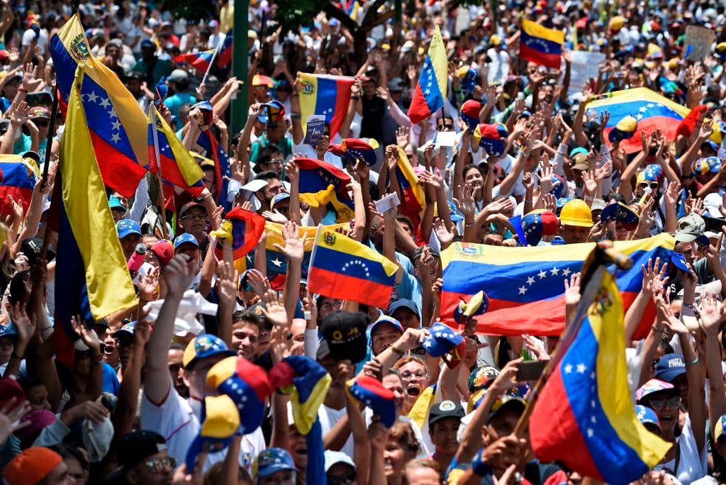 Anti-government demonstrators rally in Caracas to commemorate May Day on May 1, 2019 after a day of violent clashes on the streets of the capital spurred by Venezuelan opposition leader Juan Guaido's call on the military to rise up against President Nicolas Maduro.