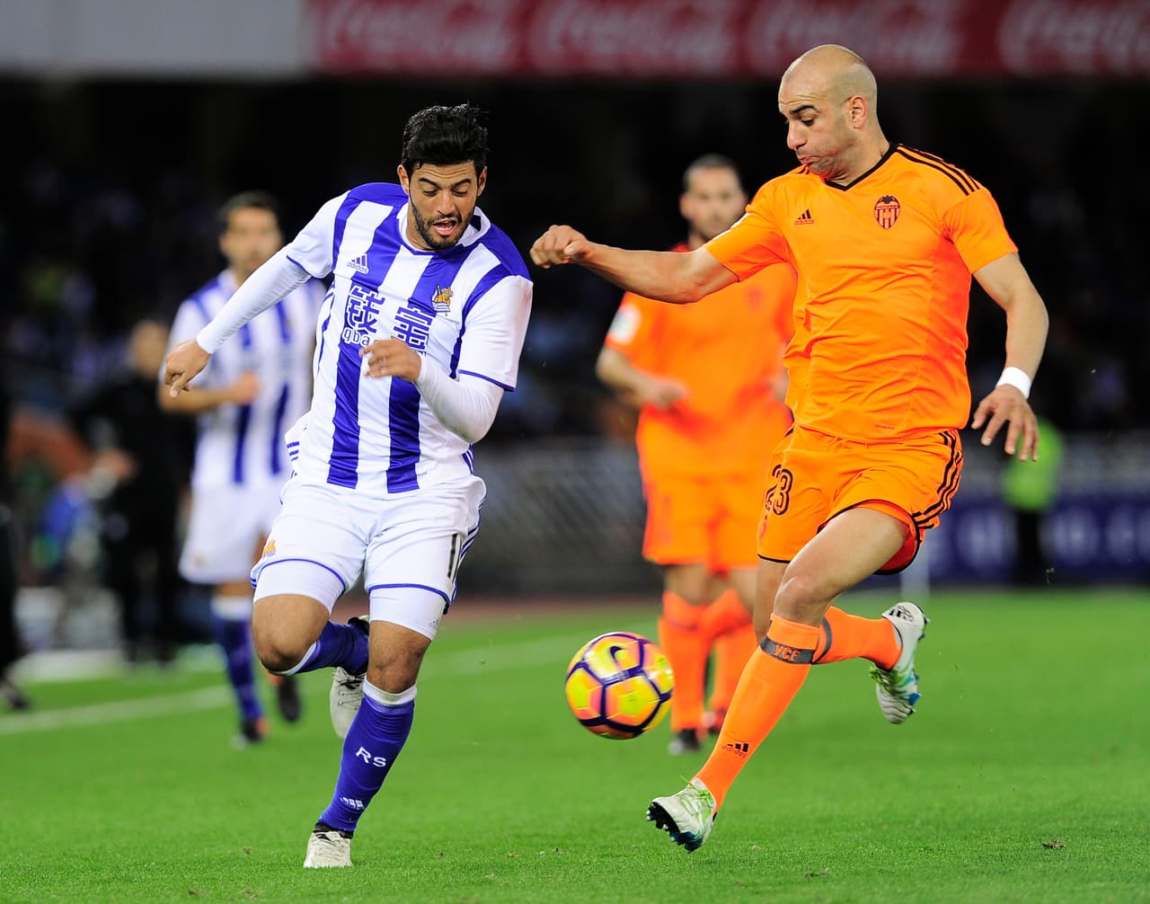 Real Sociedad's Mexican forward Carlos Vela (L) vies with Valencia's Tunisian defender Aymen Abdennour (R) during the Spanish league football match Real Sociedad vs Valencia CF at the Anoeta stadium in San Sebastian on December 10, 2016. / AFP / ANDER GILLENEA (Photo credit should read ANDER GILLENEA/AFP/Getty Images)