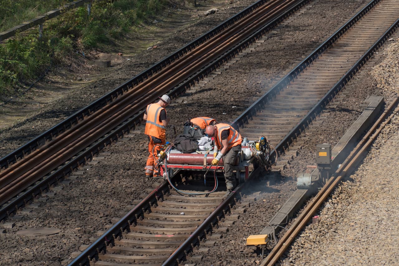 Berlin, Germany - April 19, 2019: Rail track maintenance. A team of railroad workers inspecting and repairing a railway track