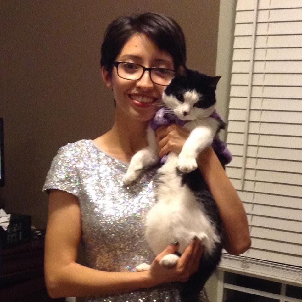 Zacarias with her cat Puppet. According to her father, the cat still awaits for her at the door of the house.