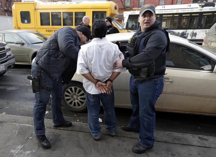 ICE officers make an arrest in New York City in 2015.