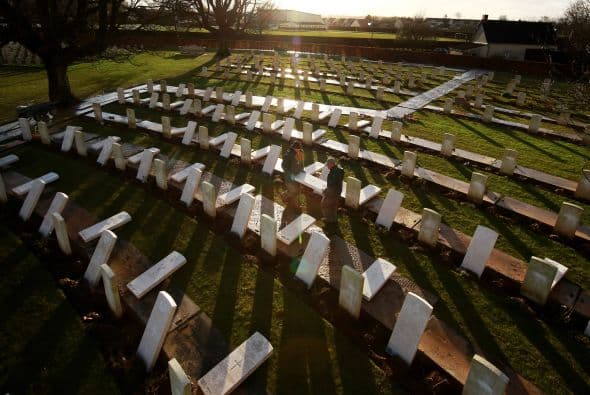 Contratistas llevan una lápida recién hecha a un cementerio de Arras, Francia.