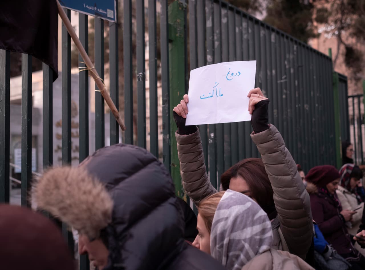 Una mujer iraní sostiene una pancarta que dice en persa "La mentira nos mató", en una protesta en Teherán para recordar a las víctimas del avión ucraniano derribado por Irán.