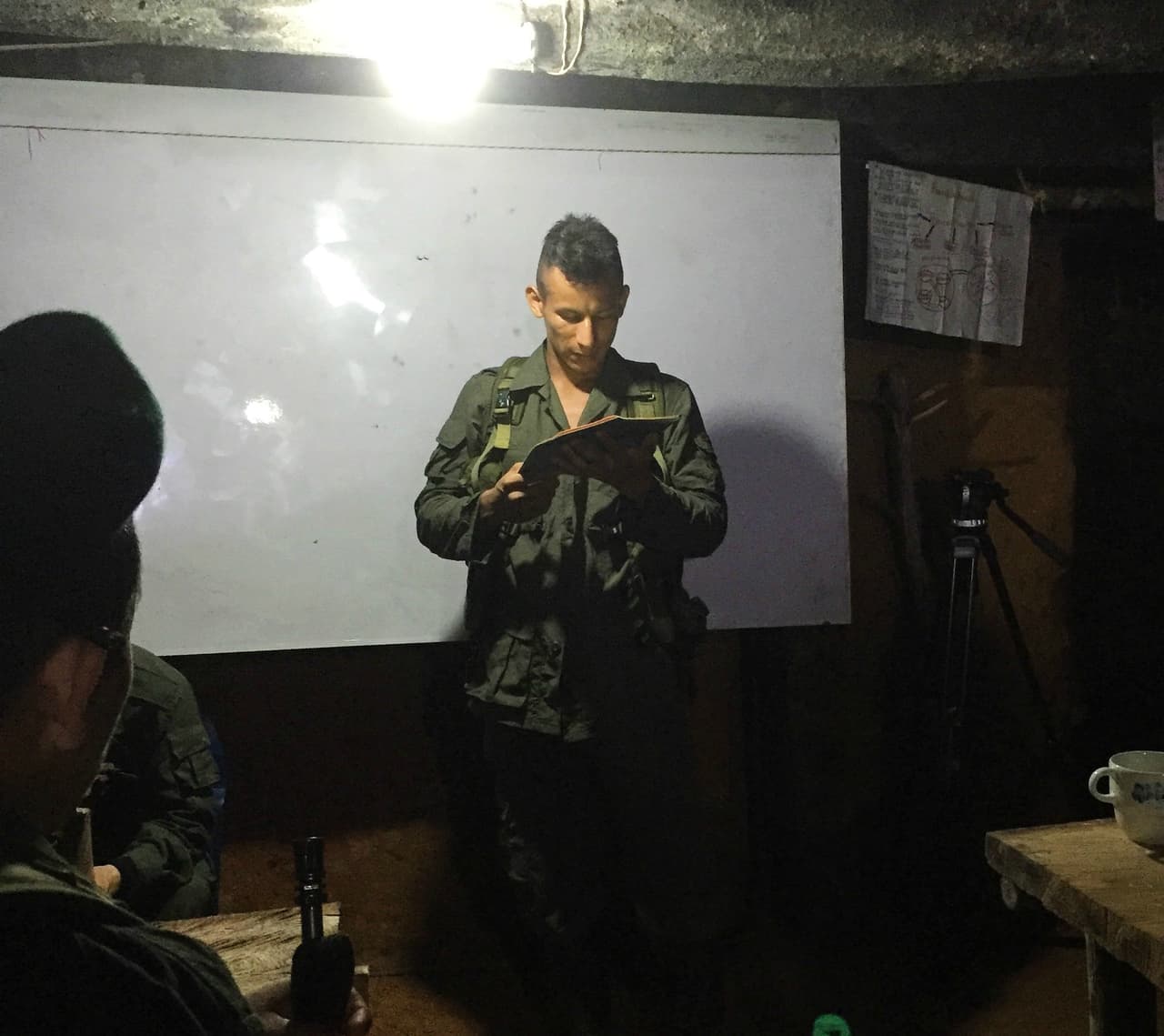 FARC fighters study in an underground classroom at a rebel camp in southern Colombia