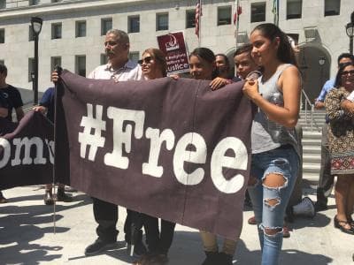 Rómulo Avélica with his family and part of a banner after winning his freedom.