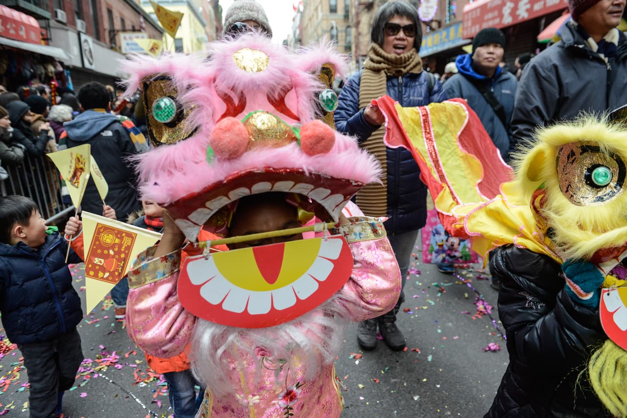 La gente lleva una decoración tradicional del dragón en Chinatown.
