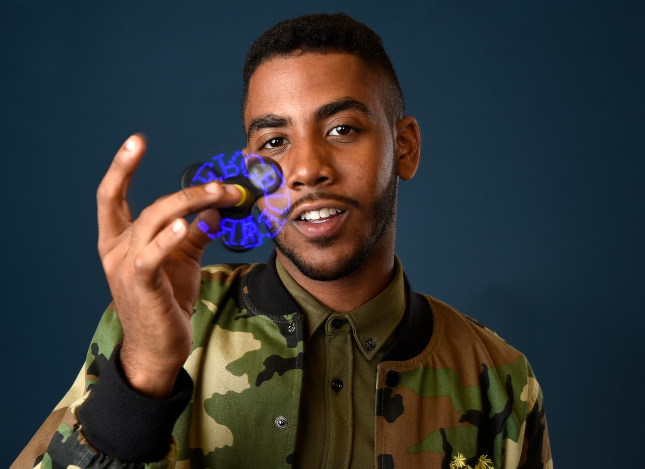 Jharrel Jerome poses with a fidget spinner that reads "Mr. Mercedes" during a portrait to promote the television series on day three of Comic-Con International on Saturday, July 22, 2017, in San Diego. (Photo by Chris Pizzello/Invision/AP)