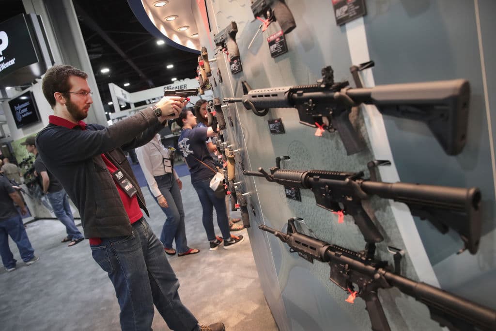 National Rifle Association members look over guns in the Smith & Wesson display at the 146th NRA Annual Meetings & Exhibits on April 29, 2017 in Atlanta, Georgia.
