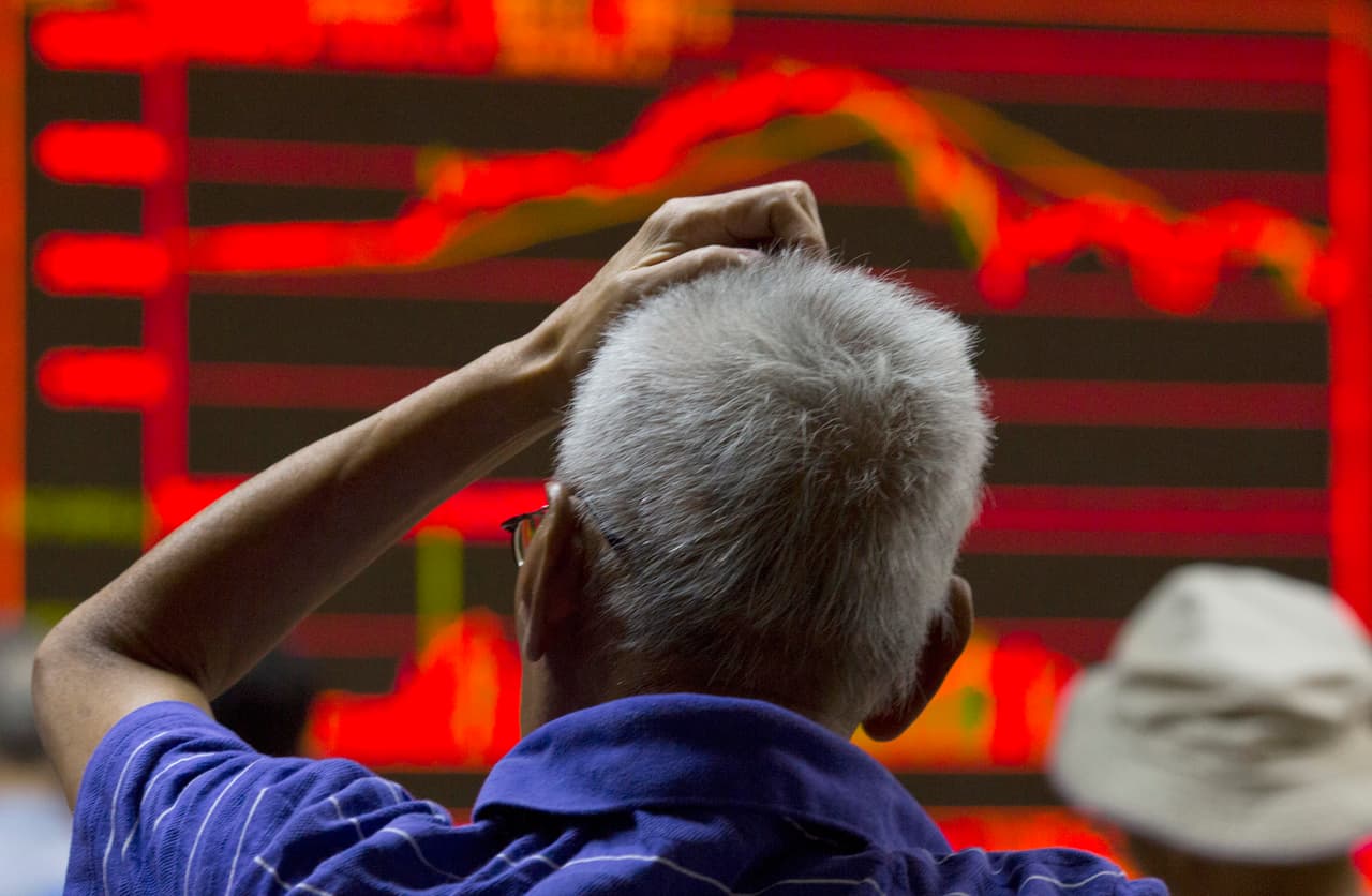 An investor scratches his head near an electronic board displaying market movements at a brokerage in Beijing, Monday, Aug. 31, 2015. Asian stocks fell Monday after a U.S. Federal Reserve official suggested a September interest rate hike still was possible and Japanese factory activity weakened. (AP Photo/Ng Han Guan)