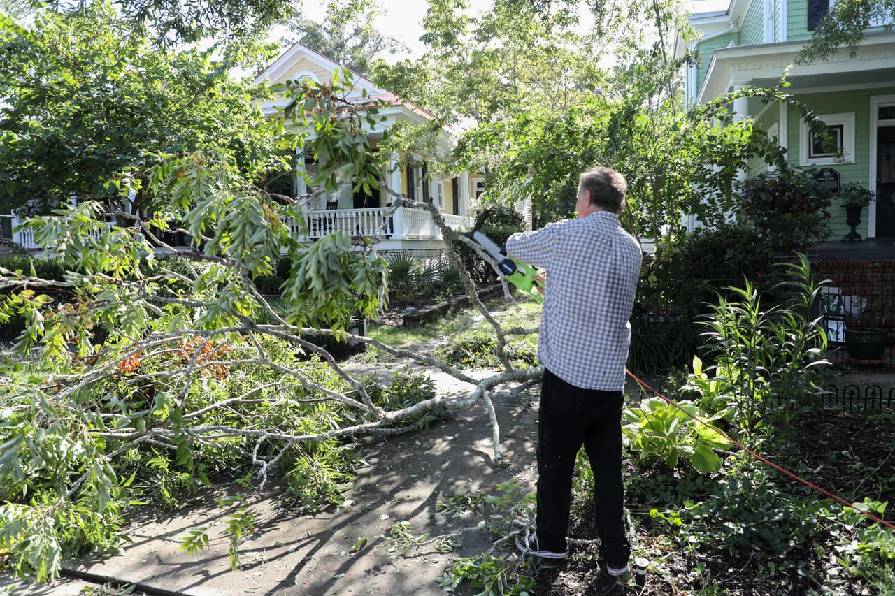 Los árboles caídos fueron una constante alrededor de las calles de Wilmington. Un residente del lugar intentaba despegar la avenida con una motosierra.