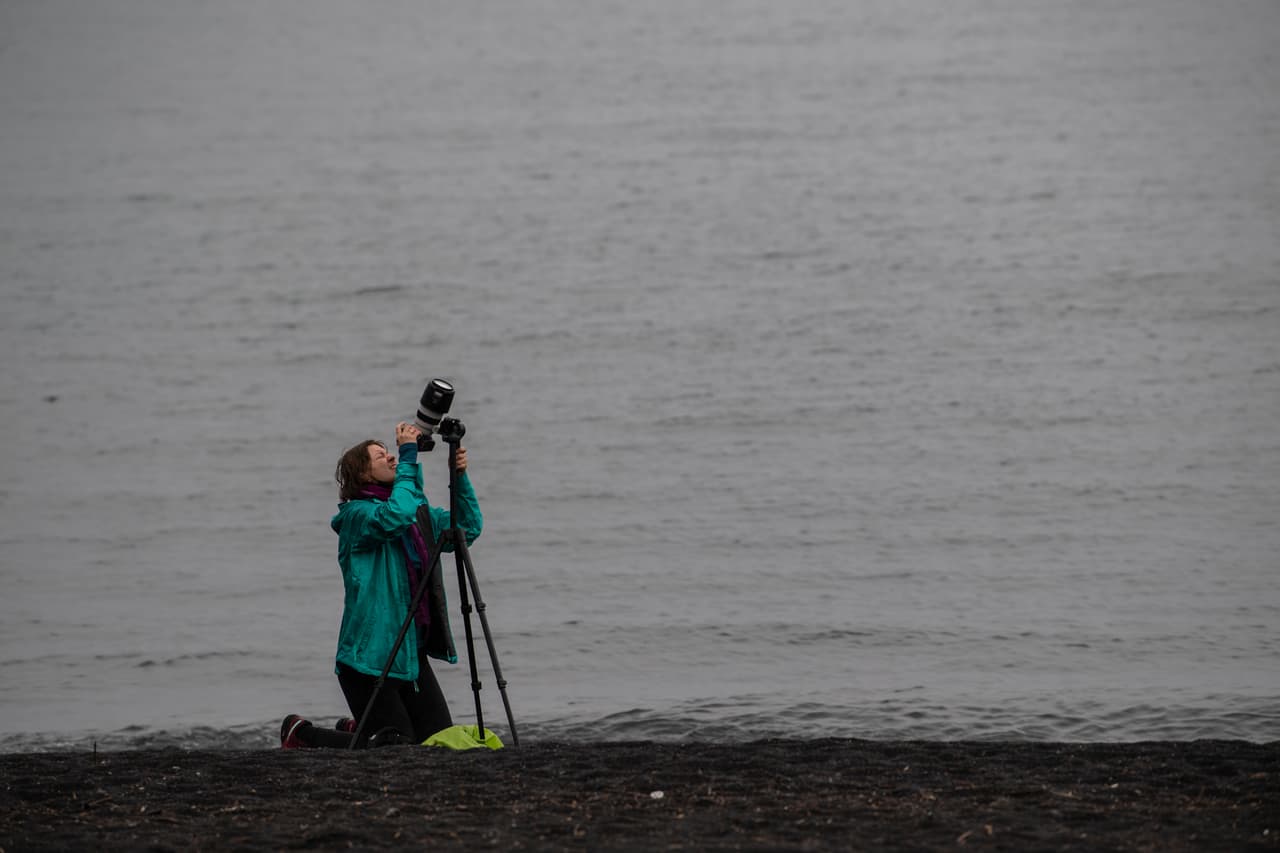 Una fotógrafa durante el eclipse total de sol en las orillas del lago Villarrica en Pucón -en el sur de Chile-, este lunes de lluvia en la región entorpeció la visibilidad.
<br>
<br>El eclipse solar alcanzó primero a Chile, ingresando por el municipio de Saavedra, a unos 800 kilómetros de Santiago y en donde se alcanzó el 100% de oscuridad a pesar del clima.