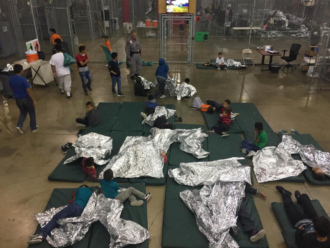Children separated in metal cages with thermal blankets in a migrant processing center at the Rio Grande City Border patrol office in Texas.