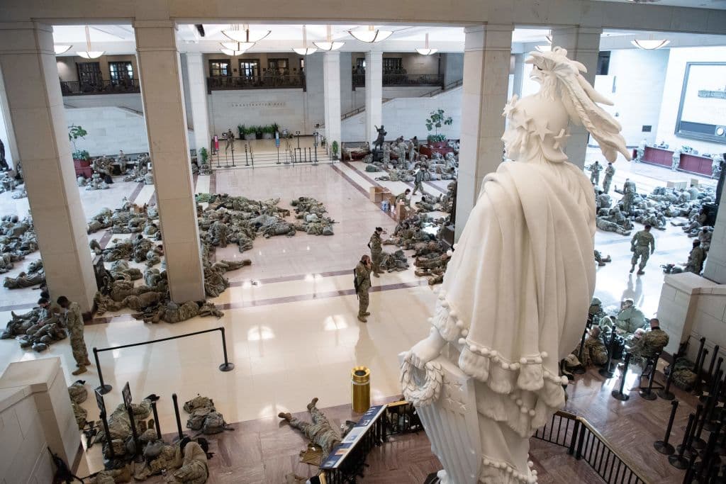 The Statue of Freedom looks down over resting National Guard soldiers, the focal point of Emancipation Hall in the Capitol Visitors Center on Capitol Hill, Washington, DC, January 13, 2021.