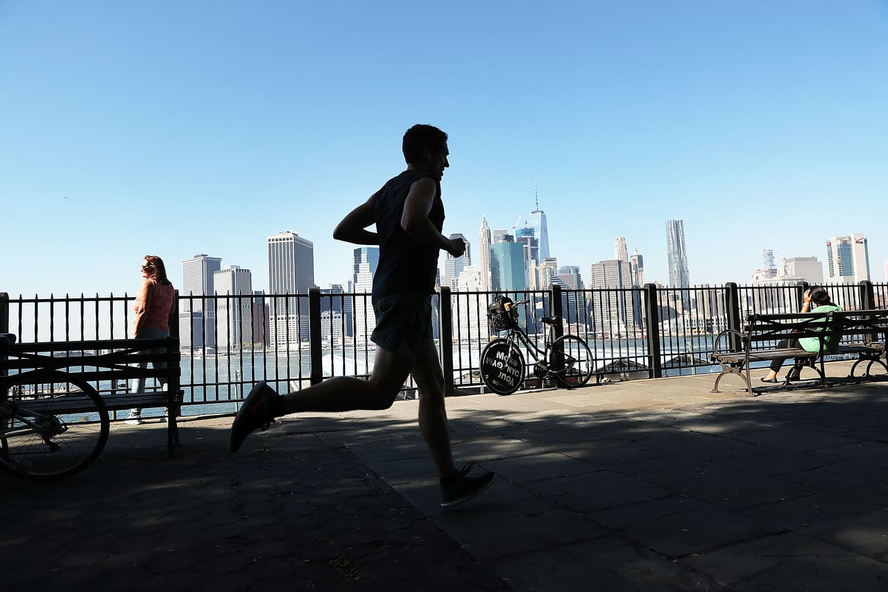 NEW YORK, NY - OCTOBER 18: A man jogs along a promanade on a summer like day on October 18, 2016 in the Brooklyn borough of New York City. New York and much of the East Coast is experiencing an Indian Summer as temperatures reach into the high 70's. (Photo by Spencer Platt/Getty Images)