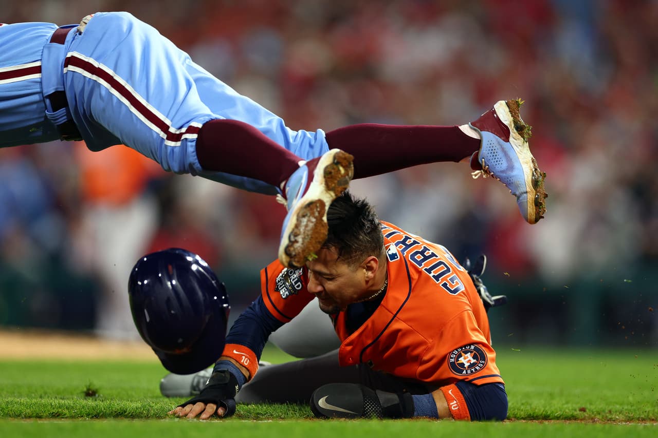 Yuli Gurriel # 10 de los Astros de Houston es atrapado en un resumen y Rhys Hoskins # 17 de los Phillies lo elimina durante la séptima entrada.