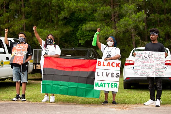 A las afueras de la iglesia de Raeford, donde se lleva a cabo el segundo funeral de Floyd, se protesta por el exceso policial contra la población afroamericana.