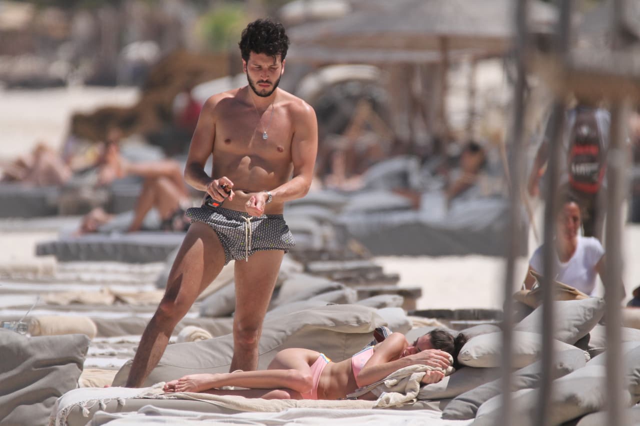 Tini se apresuró a acostarse, mientras Sebastian se untaba bloqueador solar.