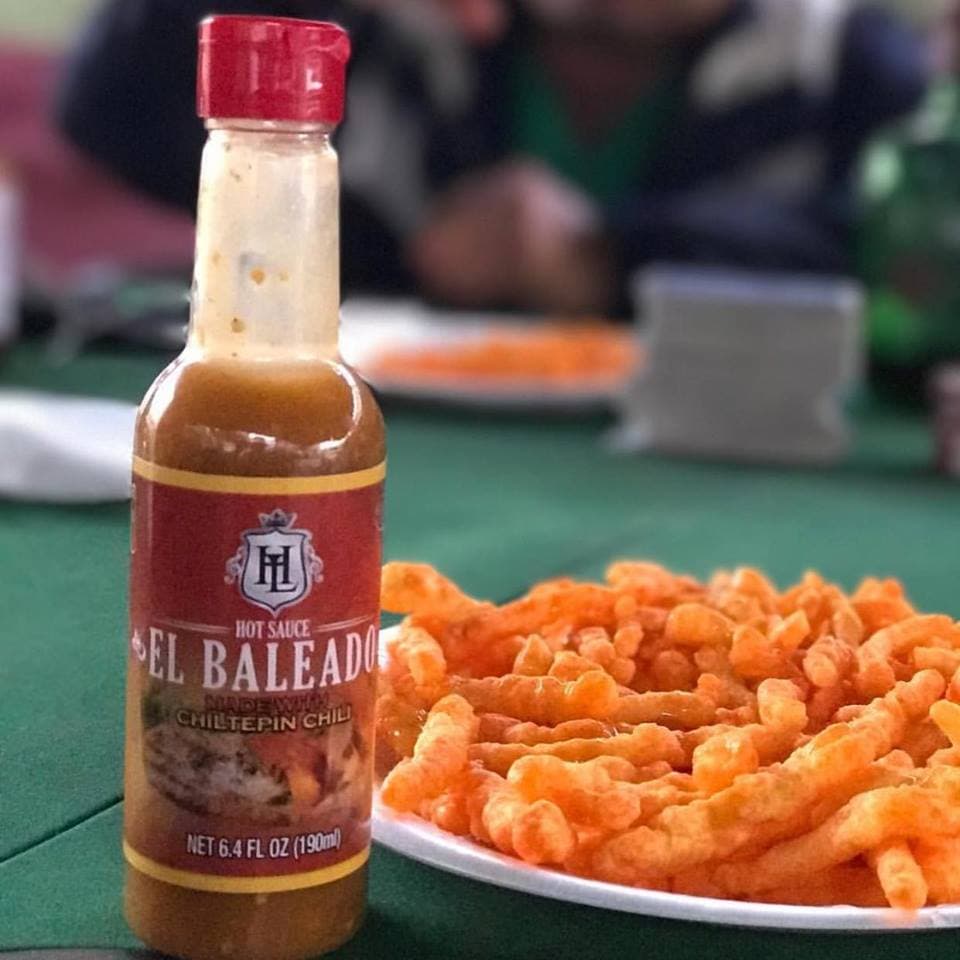 La salsa 'El Baleado', también título de uno de sus temas musicales, está disponible en dos presentaciones y se realiza con chiles chiltepin piscados en la sierra de Mocorito en Sinaloa.