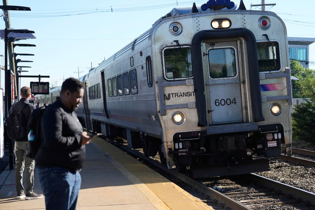 People wait to board a NJ Transit train in Hackensack, N.J., Tuesday, May 20, 2025. (AP Photo/Seth Wenig)