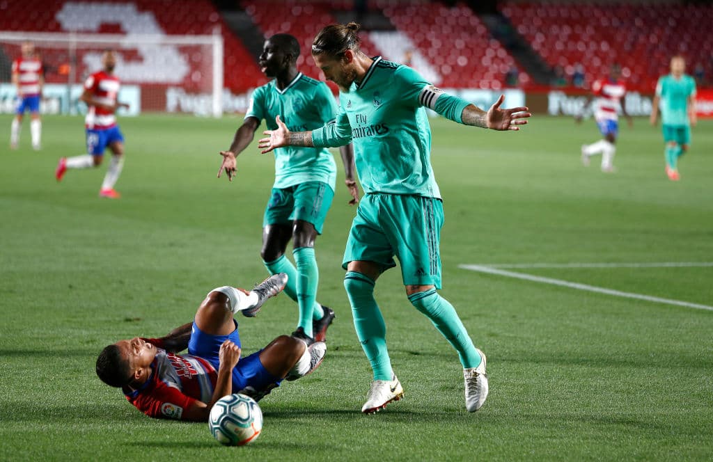 GRANADA, SPAIN - JULY 13: Sergio Ramos of Real Madird gestures after a tackle against Darwin Machís of Granada during the Liga match between Granada CF and Real Madrid CF at on July 13, 2020 in Granada, Spain. Football Stadiums around Europe remain empty due to the Coronavirus Pandemic as Government social distancing laws prohibit fans inside venues resulting in all fixtures being played behind closed doors. (Photo by Fran Santiago/Getty Images)