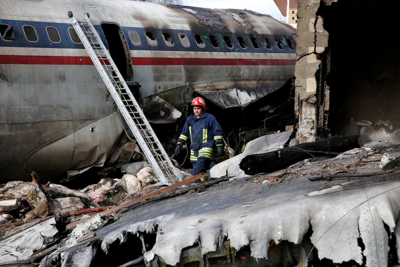 This photo provided by Mizan News Agency, shows an Iranian rescue works at the site of a Boeing 707 cargo plane crash, at Fath Airport about 40 kilometers (25 miles) west of Tehran, Iran, Monday, Jan. 14, 2019. An Iranian emergency management official has told state TV that 16 people were on board a Boeing 707 cargo plane that crashed west of Tehran and that there is only one known survivor. (Hasan Shirvani/Mizan News Agency via AP)