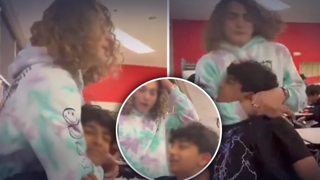 Estudiante hace una llave al cuello a un compañero frente a la cámara; ambos son suspendidos