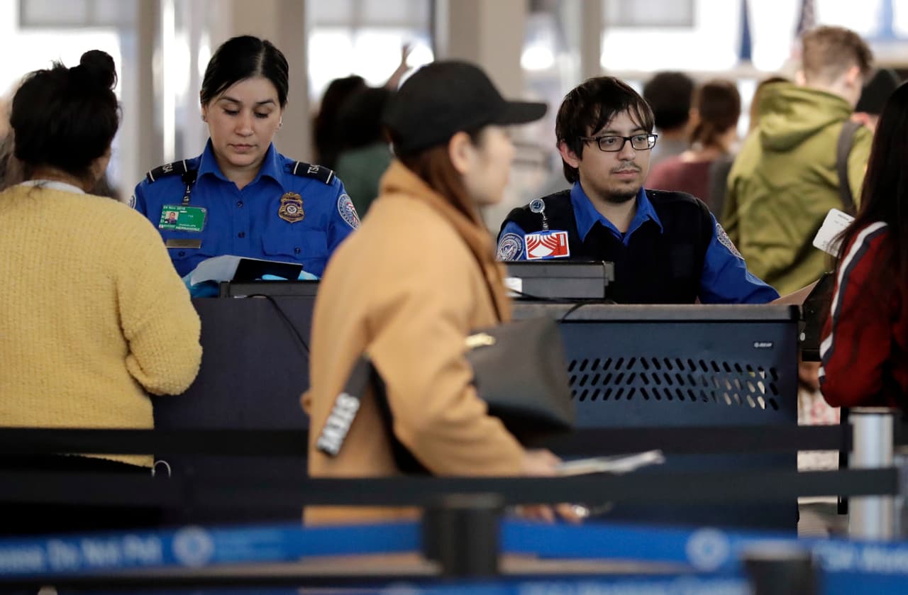 TSA workers work at O'Hare International Airport on Christmas day in Chicago, Tuesday, Dec. 25, 2018. The National Treasury Employees Union says some federal government employees already are feeling the effects of the partial government shutdown. Of the roughly 800,000 federal employees facing deferred pay, more than half were deemed essential, such as U.S. Secret Service agents and Transportation Security Administration airport agent. About 380,000 were to be furloughed. Legislation ensuring that workers receive back pay was expected to clear Congress. (AP Photo/Nam Y. Huh)