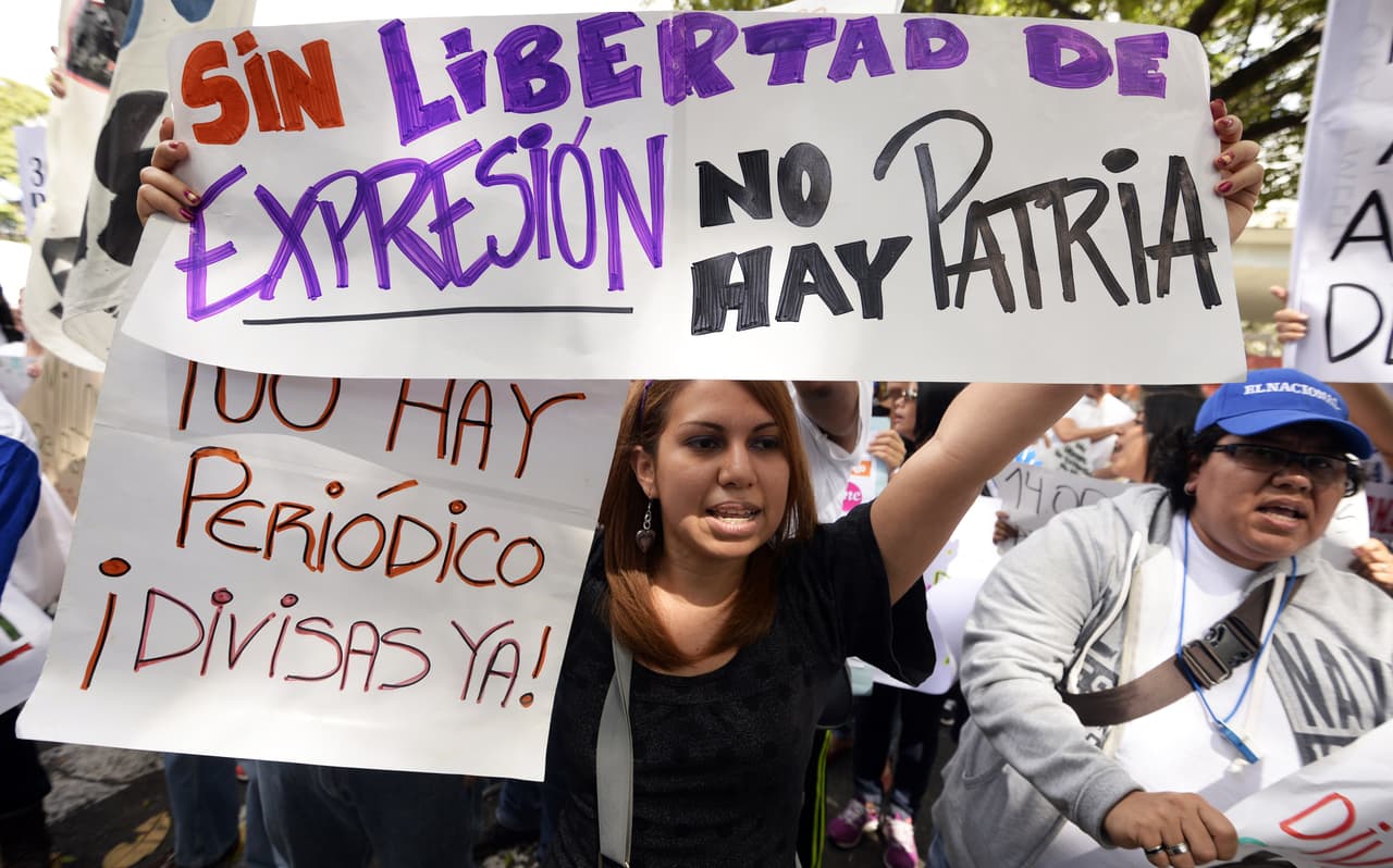 Newspaper journalists take part in a protest outside CADIVI headquarters in Caracas on January 28, 2013. About 500 newspaper workers demanded to the government the release of US dollars to buy paper, presently in shortage in Venezuela. AFP PHOTO/JUAN BARRETO (Photo credit should read JUAN BARRETO/AFP/Getty Images)