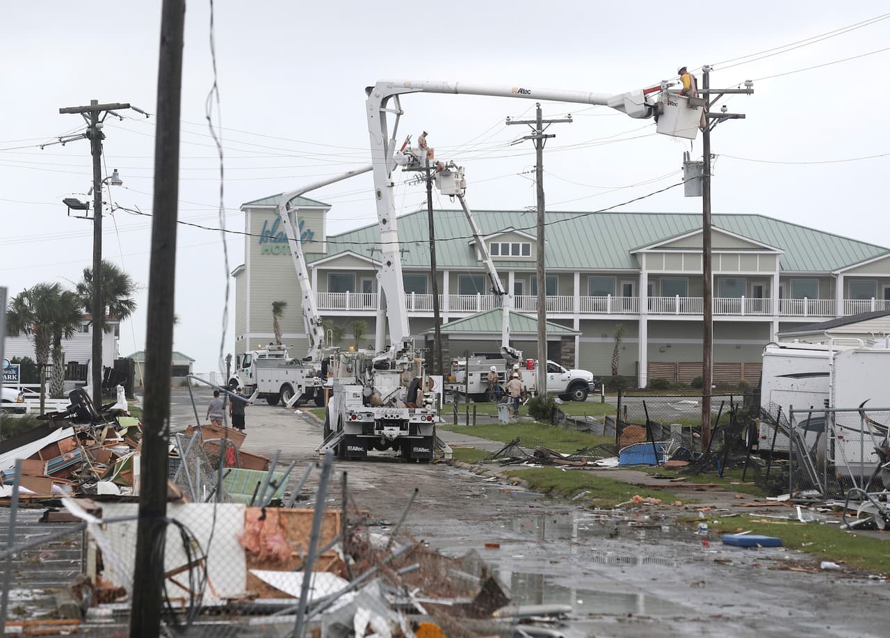 Power company linemen work to restore power after a tornado hit Emerald Isle N.C. as Hurricane Dorian moves up the East coast on Thursday, Sept. 5, 2018. (AP Photo/Tom Copeland)