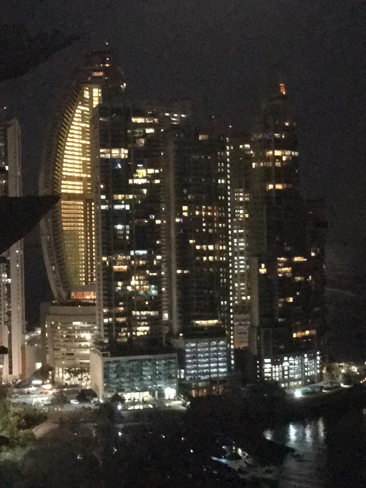 The Trump Ocean Club International Hotel & Tower (on left with lights) at night.