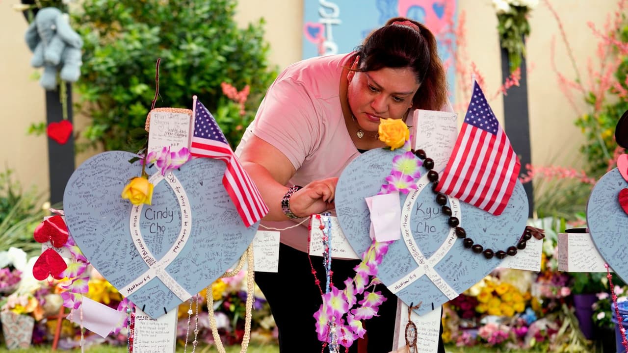 Erika, de Fort Worth, Texas, que no quiso compartir su apellido, deja un mensaje en un monumento improvisado junto al centro comercial en Allen donde murieron varias personas.