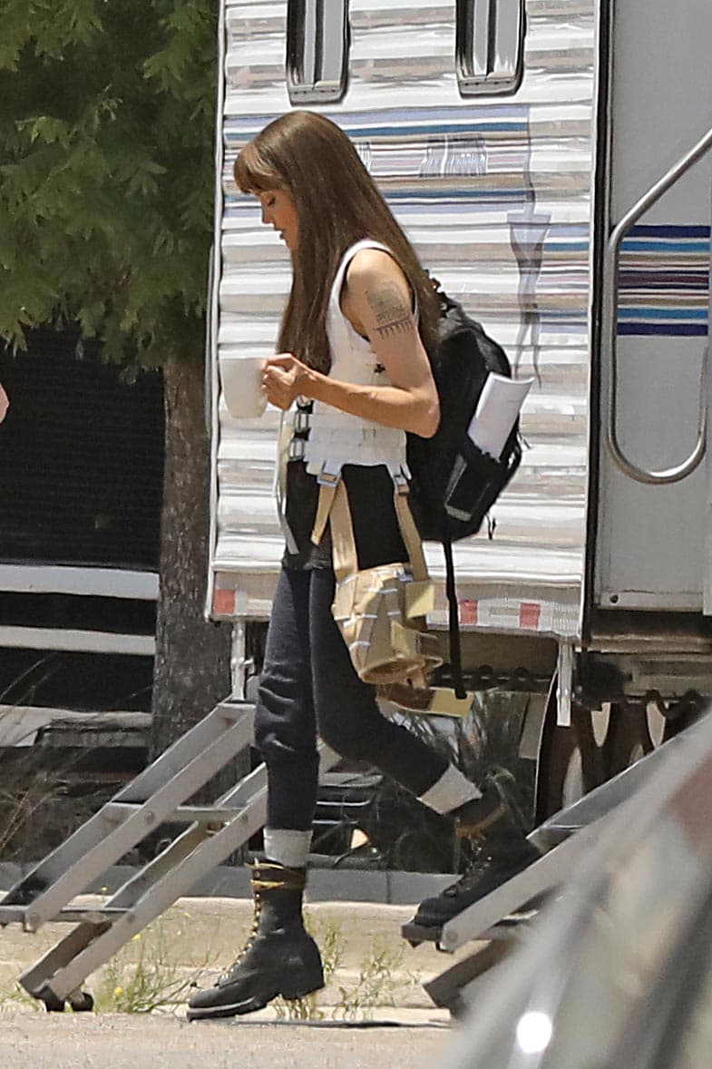 Y en esta otra, usa una camiseta blanca, pantalones vaqueros oscuros y botas de combate, en referencia al intrépido personaje que interpreta.