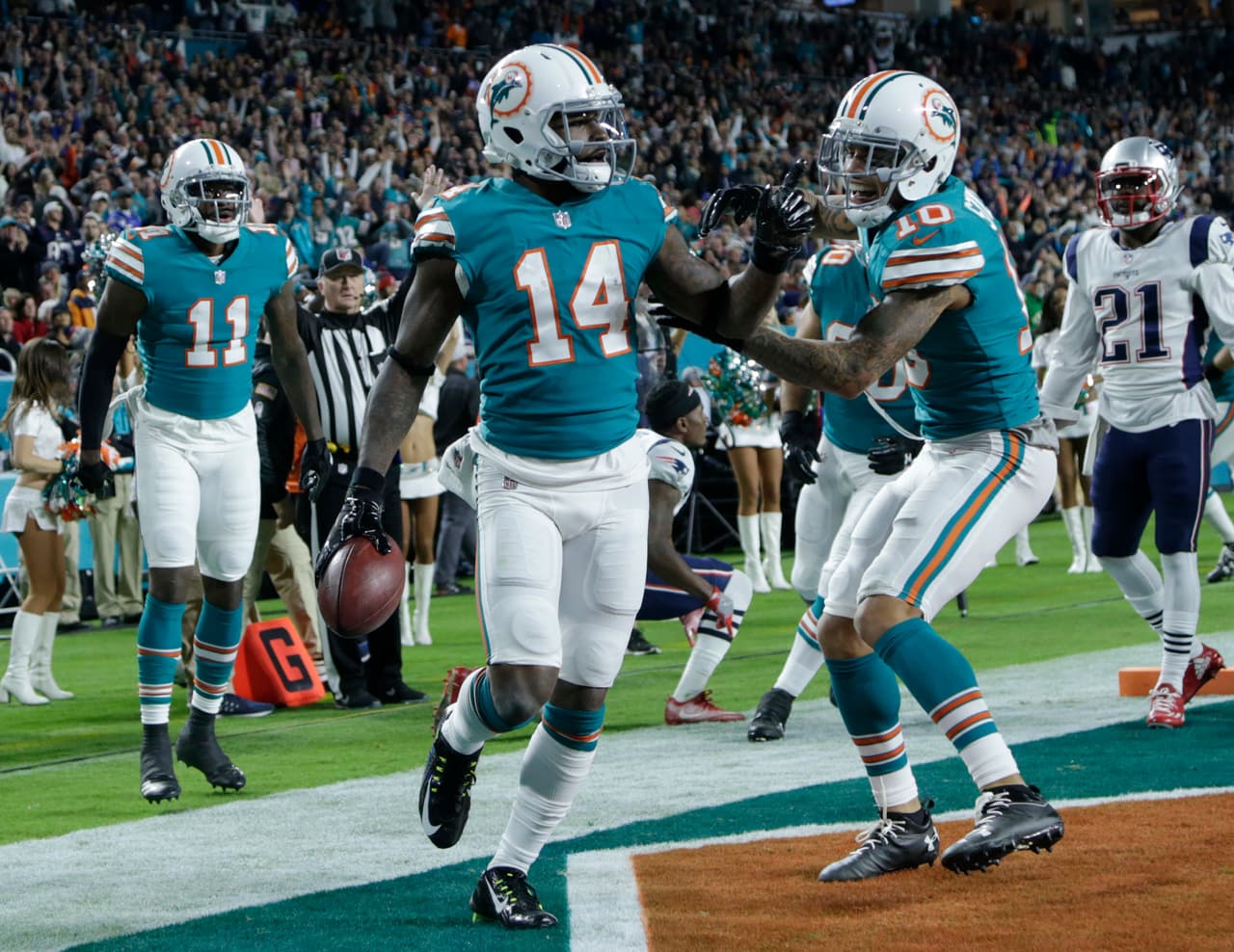 Miami Dolphins wide receiver Kenny Stills (10) congratulates wide receiver Jarvis Landry (14) after Landry scored a touchdown, during the first half of an NFL football game against the New England Patriots, Monday, Dec. 11, 2017, in Miami Gardens, Fla. (AP Photo/Lynne Sladky)