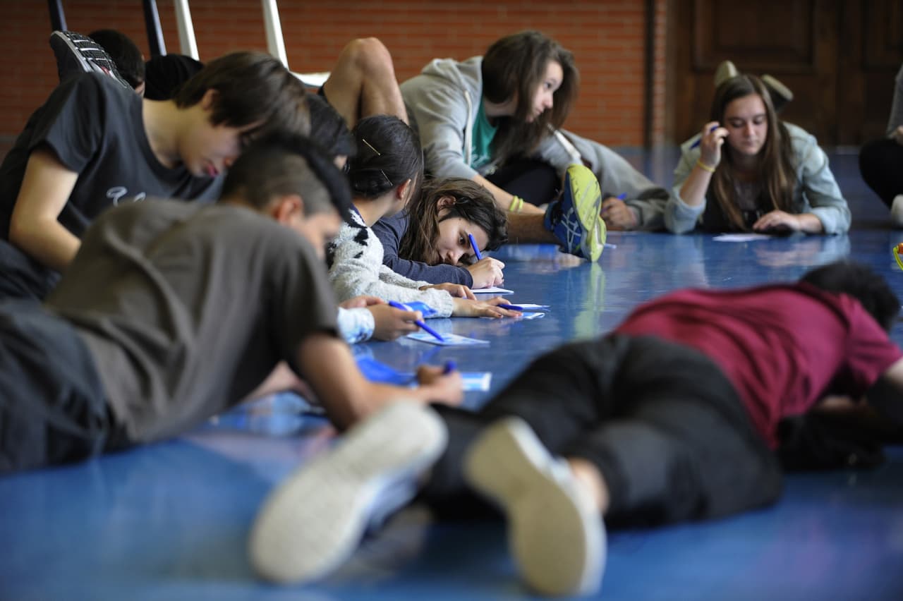 Students write down a wish and a promise after attending a theater programme about peace and coexistence, entitled "And you, what?" and organised by the Baketik Foundation at the Aldatzen Institute in the Basque town of Eibar on May 14, 2015. Four years after the separatist group ETA declared an end to its armed independence campaign, the emotional scars left by four decades of bombings and shootings remain in the Basque Country. This theater theraphy is one of the various reconciliation initiatives which have sprung up in recent years with the aim of healing them. AFP PHOTO / ANDER GILLENEA TO GO WITH AN AFP STORY BY MICHAELA CANCELA-KIEFFER (Photo credit should read ANDER GILLENEA/AFP/Getty Images)