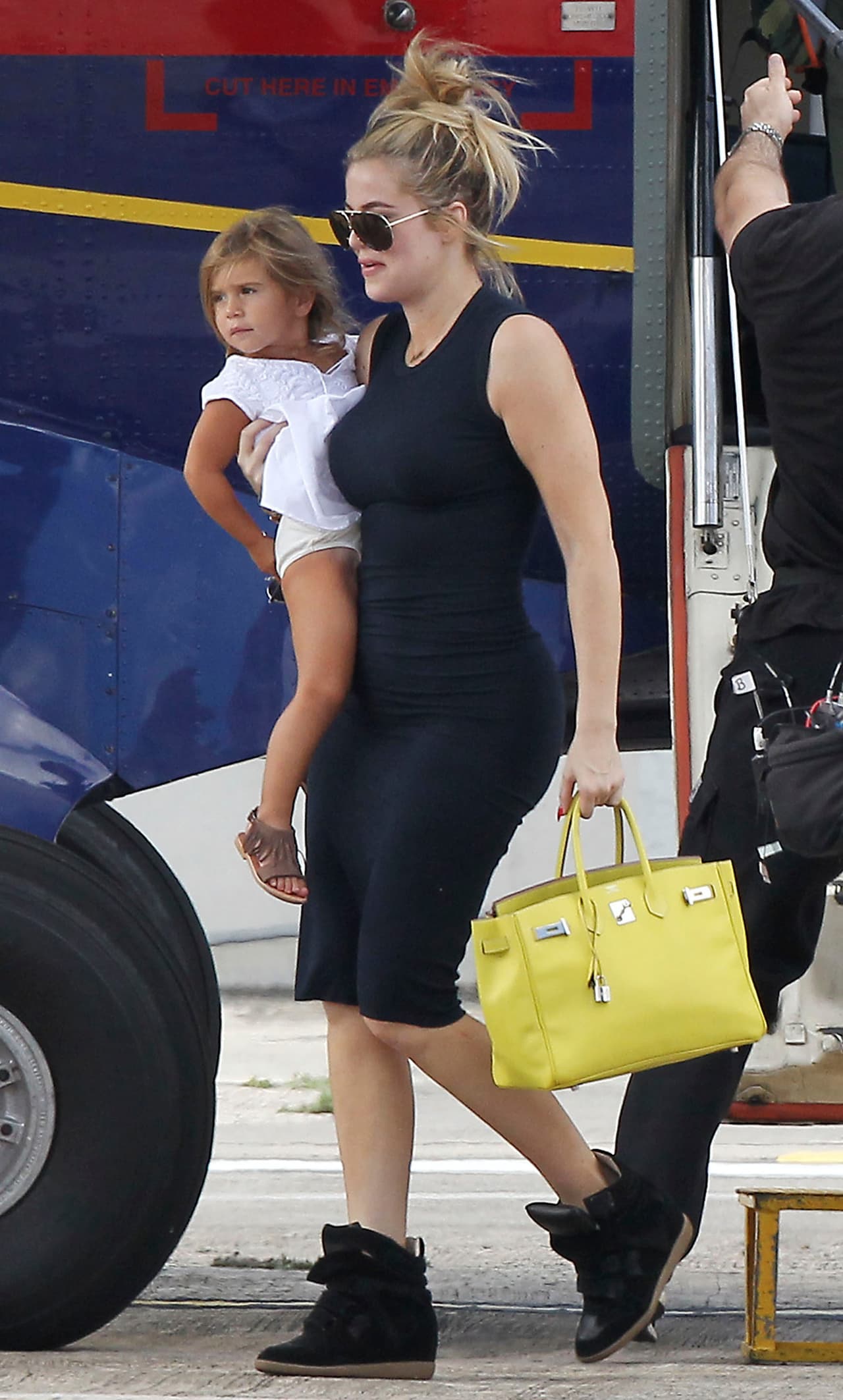 Khloé con un bolso amarillo.