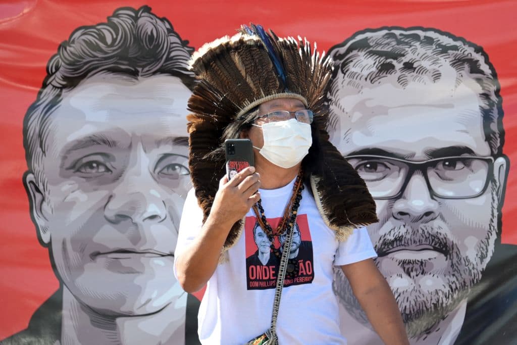 A Brazilian Kamuu Dan Wapichana indigenous man takes part in a protest of employees of the  National Indigenous Foundation (FUNAI) outside the Ministry of Justice in Brasília, on June 14, 2022 over missing British journalist Dom Phillips and Brazilian Indigenous affairs specialist Bruno Pereira.