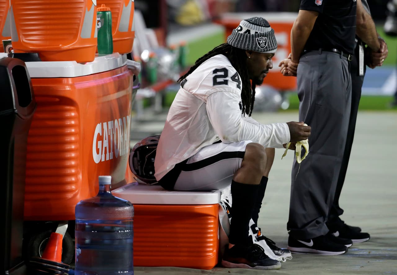 Oakland Raiders running back Marshawn Lynch (24) sits during the national anthem prior to an NFL preseason football game against the Arizona Cardinals, Saturday, Aug. 12, 2017, in Glendale, Ariz. (AP Photo/Rick Scuteri)