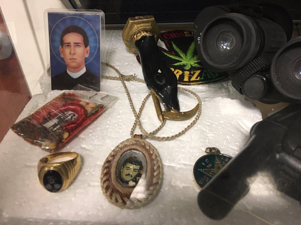 En esta imagen se observan un par de binoculares, un radio de comunicación y objetos religiosos que agentes fronterizos en el sector Tucson les han decomisado a los ‘punteros’ y transportistas de droga a lo largo de los años.