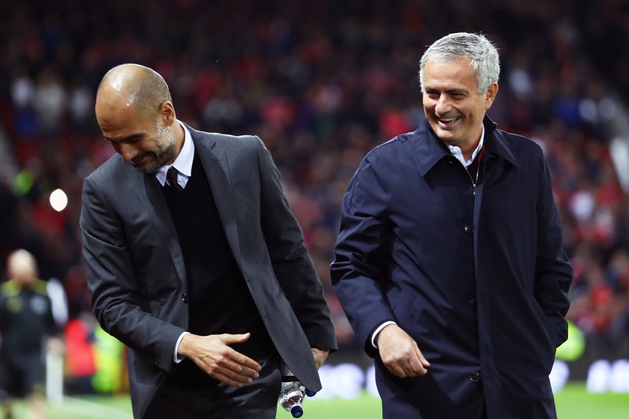 MANCHESTER, ENGLAND - OCTOBER 26: Josep Guardiola, Manager of Manchester City (L) and Jose Mourinho, Manager of Manchester United (R) share a joke prior to kick off during the EFL Cup fourth round match between Manchester United and Manchester City at Old Trafford on October 26, 2016 in Manchester, England. (Photo by Michael Steele/Getty Images)